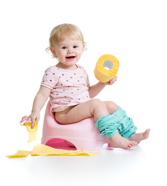 smiling-baby-sitting-on-chamber-pot-with-toilet-paper-roll